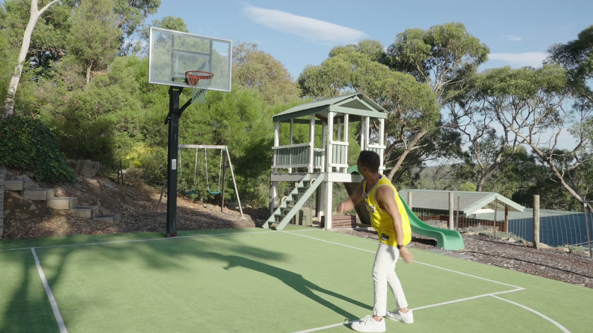 Shooting hoops on the backyard court at 9 Fern Road during the campaign film